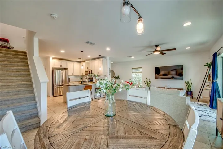 Tiled dining space featuring sink and ceiling fan