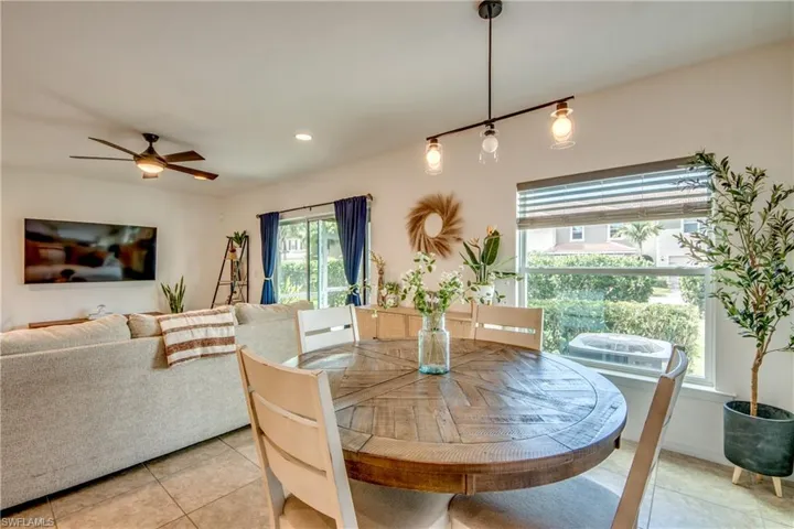 Tiled dining room with ceiling fan