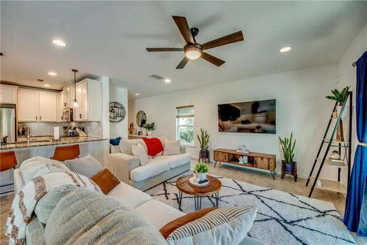 Living room featuring sink and ceiling fan