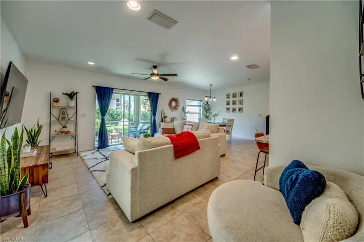 Living room featuring light tile patterned flooring and ceiling fan