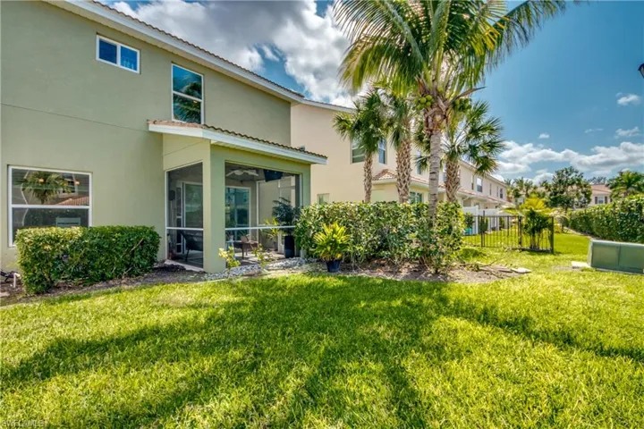 Back of property featuring a lawn