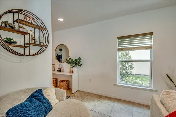 Living room with plenty of natural light and light tile patterned floors