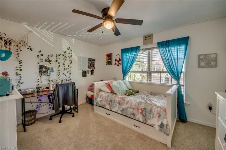 Bedroom featuring carpet and ceiling fan