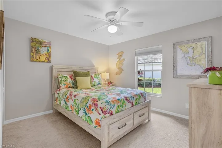 Bedroom with light colored carpet and ceiling fan