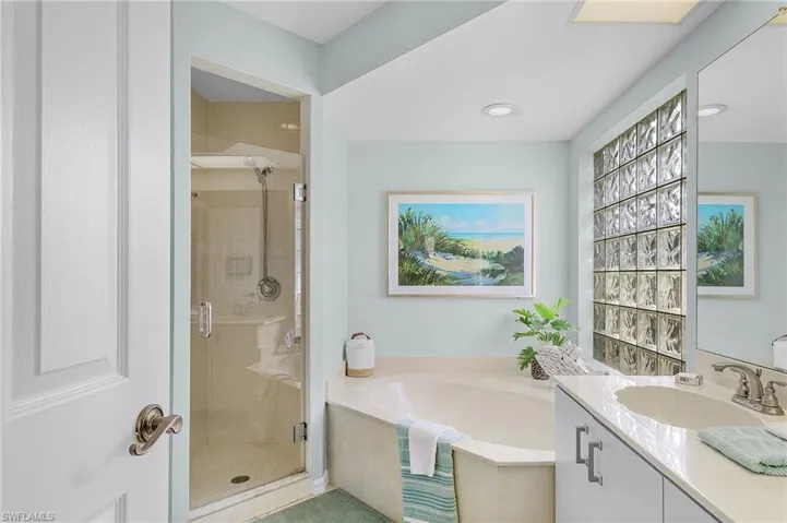 Bathroom with vanity and shower with separate bathtub