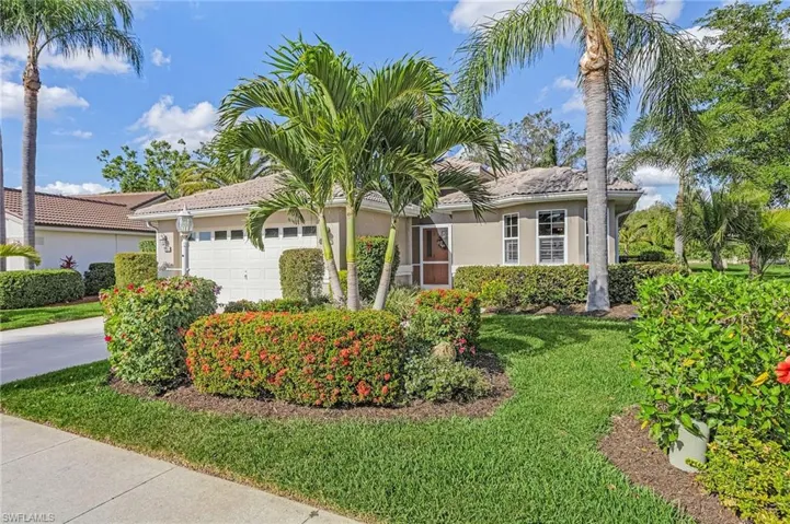 Ranch-style house with a two car garage and a front yard
