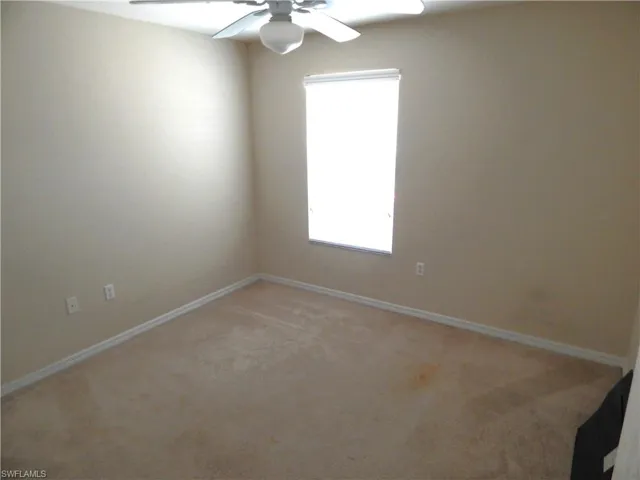 Carpeted 2nd bedroom featuring ceiling fan