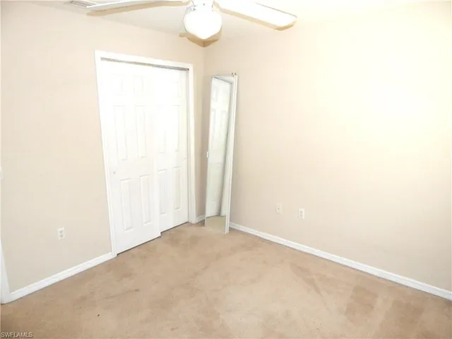 2nd bedroom bedroom with a closet, ceiling fan, and light carpet