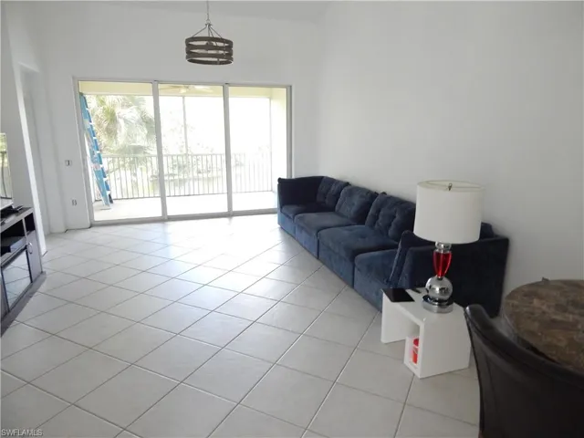 Living room featuring a chandelier and light tile patterned floors
