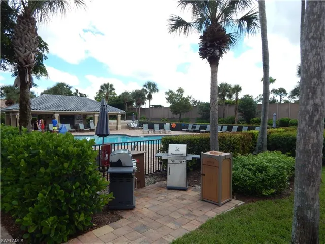 View of 2nd patio featuring a community pool and grilling area