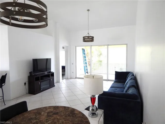 Tiled living room with a chandelier