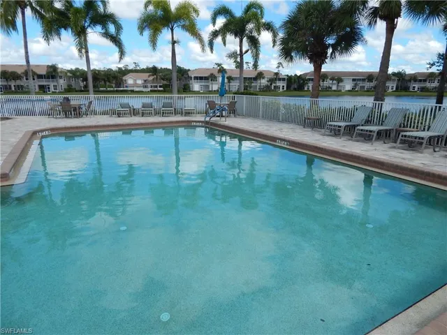 View of community swimming pool featuring a patio area