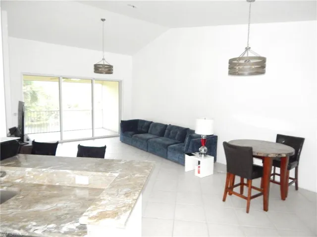 Tiled living room with lofted ceiling