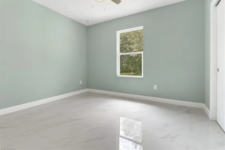 Unfurnished room featuring ceiling fan