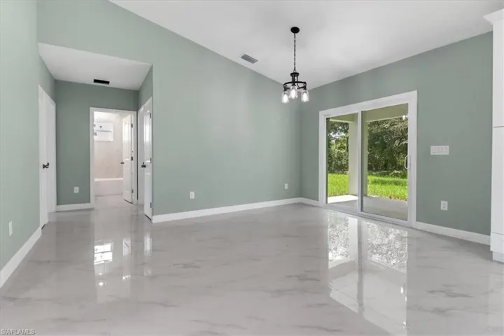 Unfurnished room with an inviting chandelier