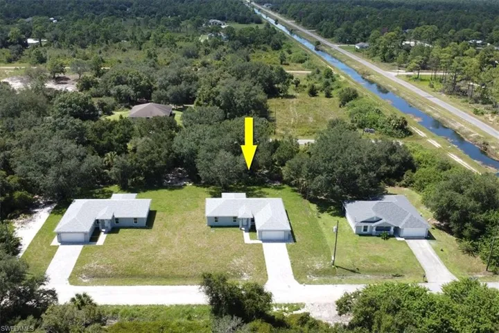 Birds eye view of property with a water view