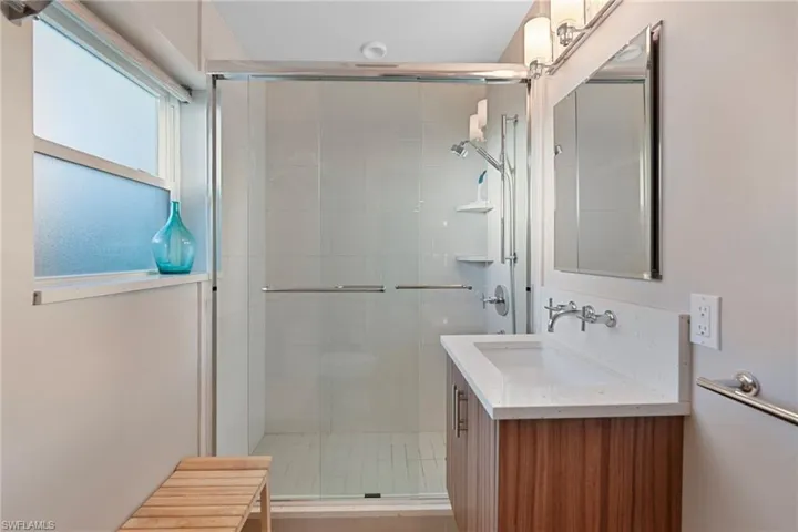Bathroom with vanity and a shower stall