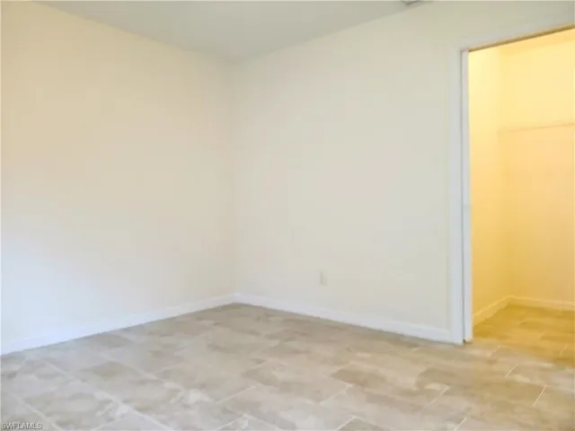 Unfurnished bedroom with light tile floors