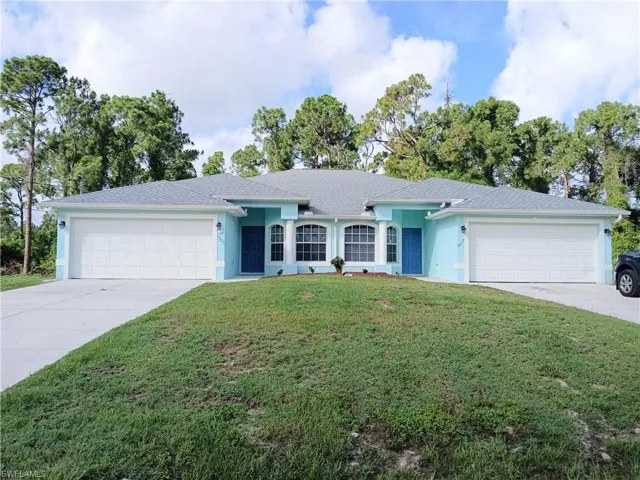 Ranch-style house featuring a garage and a front yard