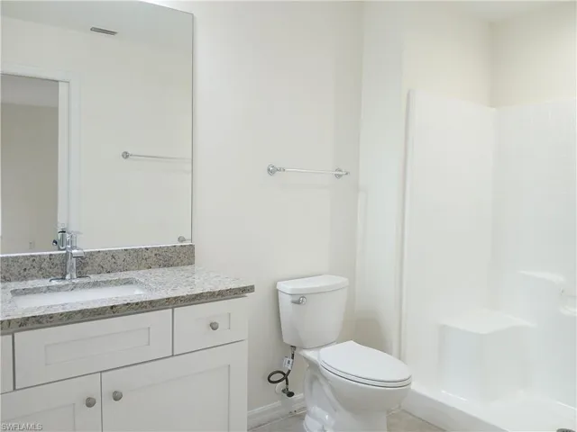 Bathroom featuring toilet and large vanity
