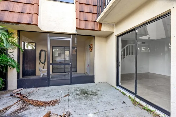View of exterior entry featuring a patio