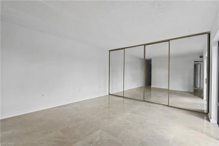 Unfurnished bedroom featuring a closet and a textured ceiling