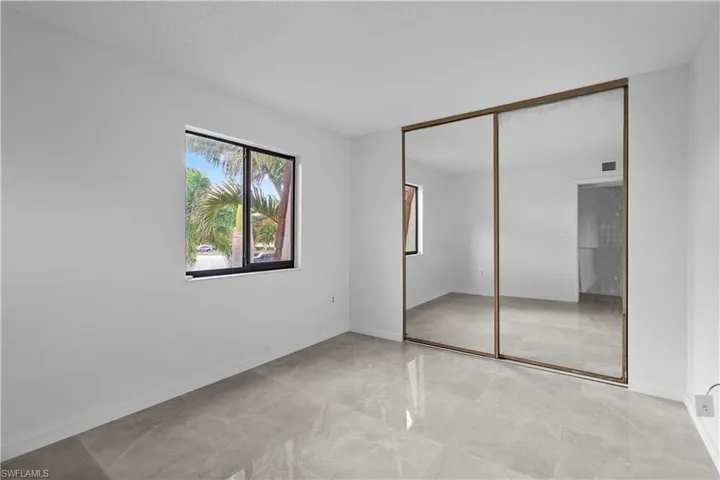 Unfurnished bedroom featuring a textured ceiling and a closet