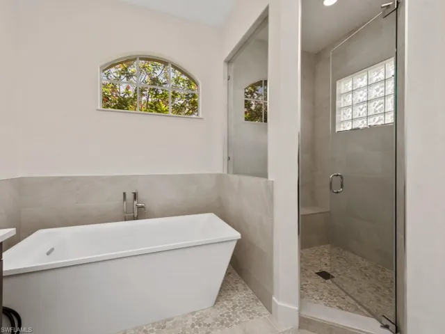 Washroom featuring washer and clothes dryer and cabinet space