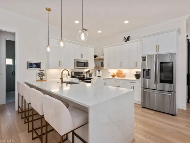 Birds eye view of property with a water view, golf course view, and a residential view