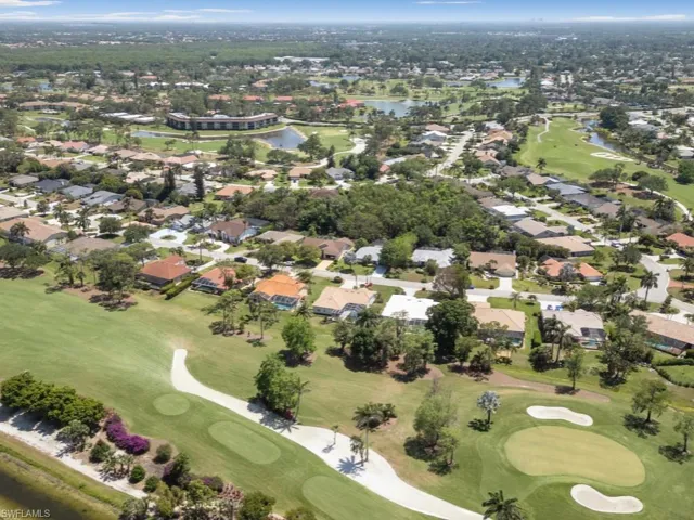 Birds eye view of property featuring view of golf course, a water view, and a residential view