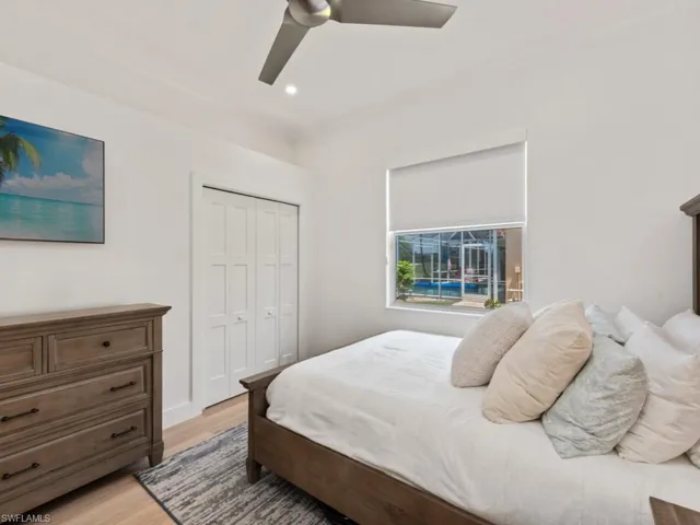 Bedroom with ceiling fan, ornamental molding, light wood-style floors, and recessed lighting