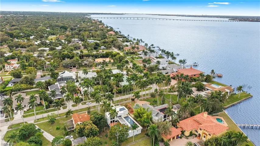 Aerial perspective of suburban area with a notable bridge and a nearby body of water
