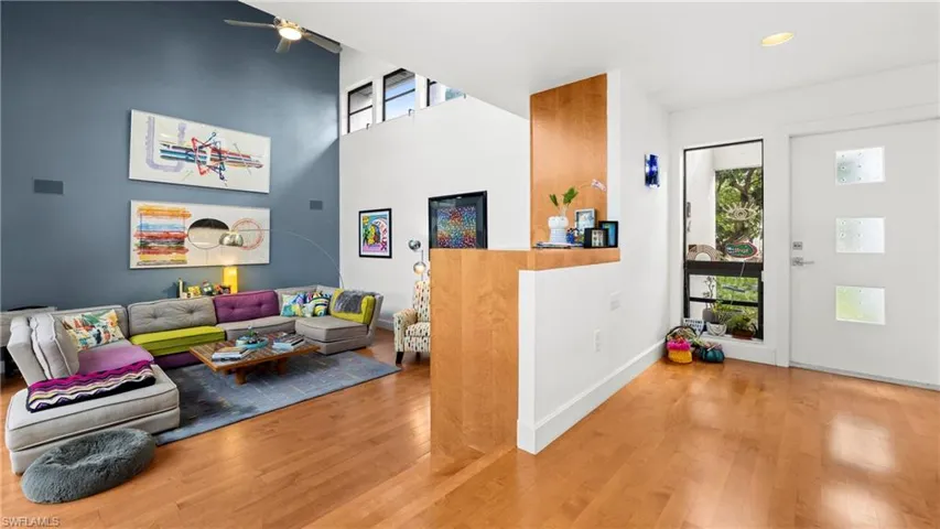 Entrance foyer featuring wood finished floors, a high ceiling, and a ceiling fan