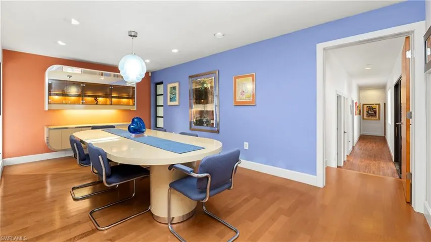 Dining area featuring light wood-style floors, recessed lighting, and radiator heating unit