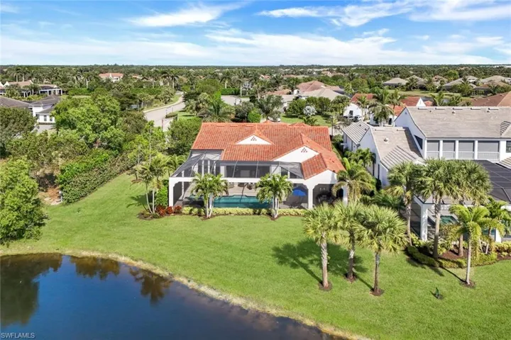 Aerial perspective of suburban area featuring a large body of water
