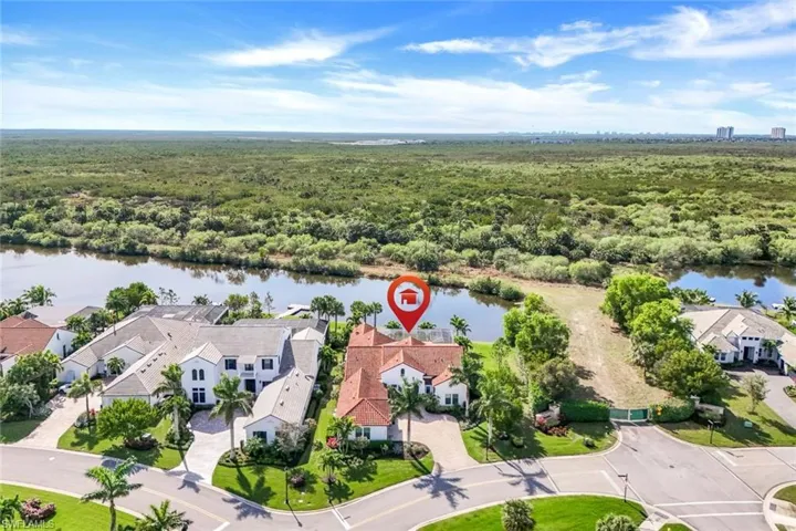 Aerial view of residential area featuring a nearby body of water