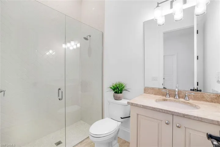 Full bathroom featuring a stall shower and vanity