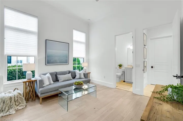 Living area with light wood finished floors and baseboards