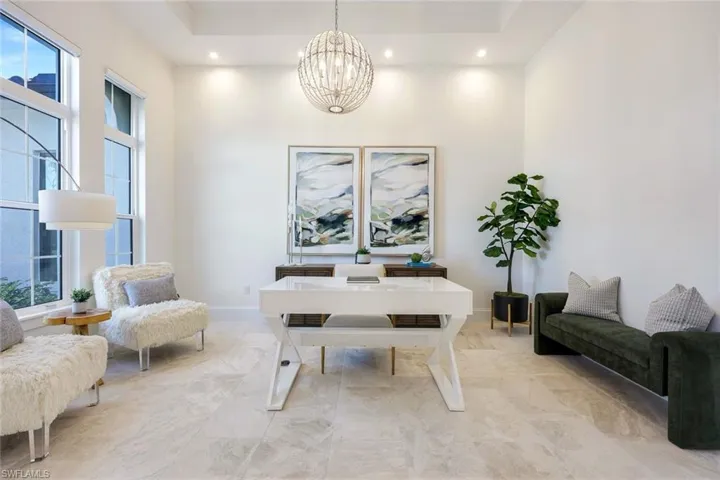 Office space featuring a high ceiling, a chandelier, and recessed lighting