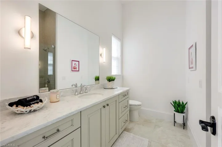 Bathroom featuring vanity and a shower