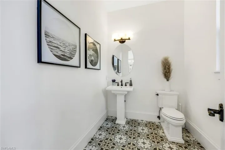 Powder Bathroom featuring toilet and tile patterned floors