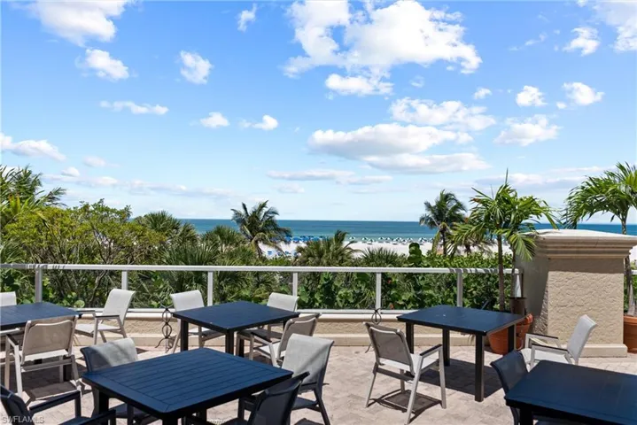 Beach Club Balcony featuring outdoor dining area and view of water and beach