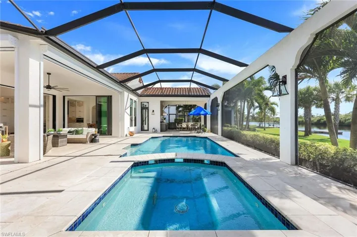 View of pool featuring a water view, a patio area, an outdoor living space, a pool with connected hot tub, and a ceiling fan