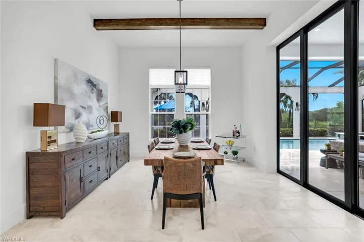 Dining area featuring beam ceiling