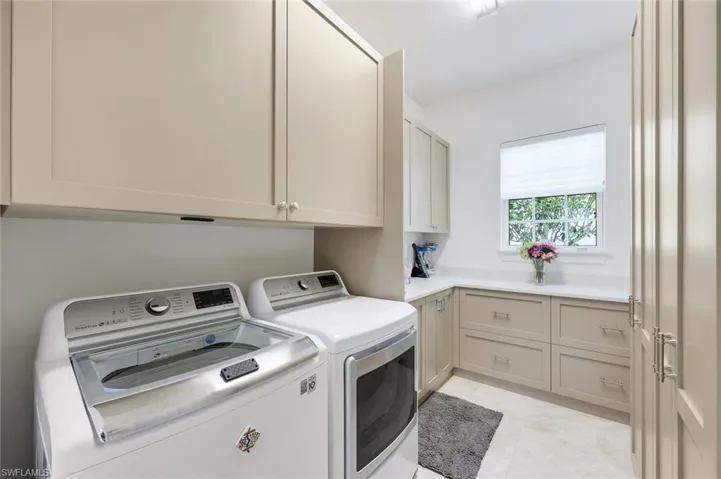 Laundry area featuring cabinet space and independent washer and dryer