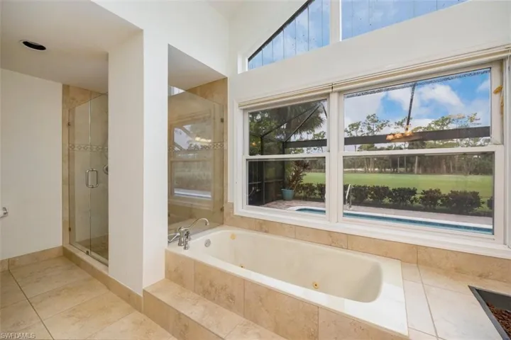 Master Full bath with a stall shower, a whirlpool tub, and tile patterned floors