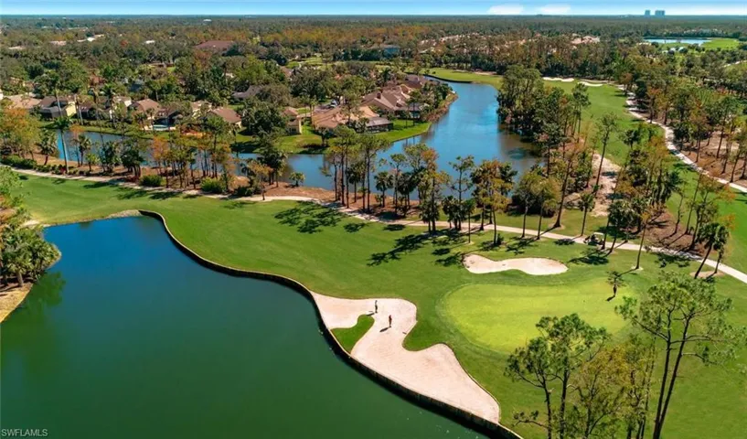 Aerial view of residential area with a large body of water and a golf club