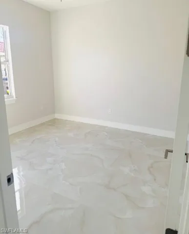 Empty room featuring baseboards