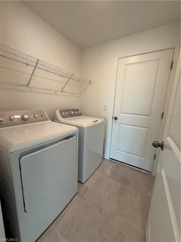 Washroom featuring independent washer and dryer
