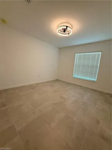 Empty room featuring baseboards